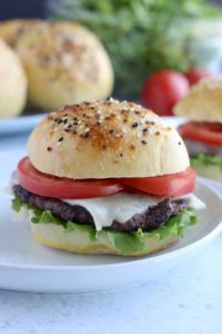 delicious hamburger with lettuce, mozzarella and tomatoes sandwiched in two homemade buns